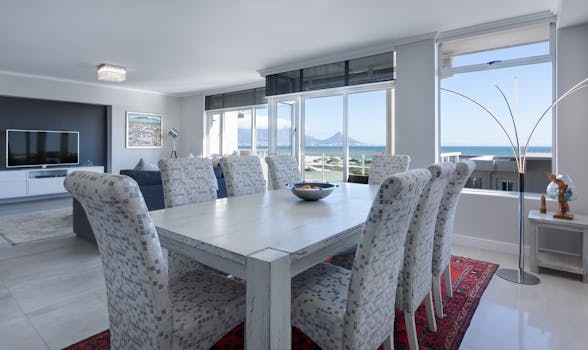 Luxurious dining room in Cape Town with modern furniture and ocean views.